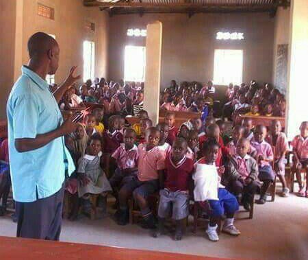 Nampwera Frank speaking with students at Bright Early Age School